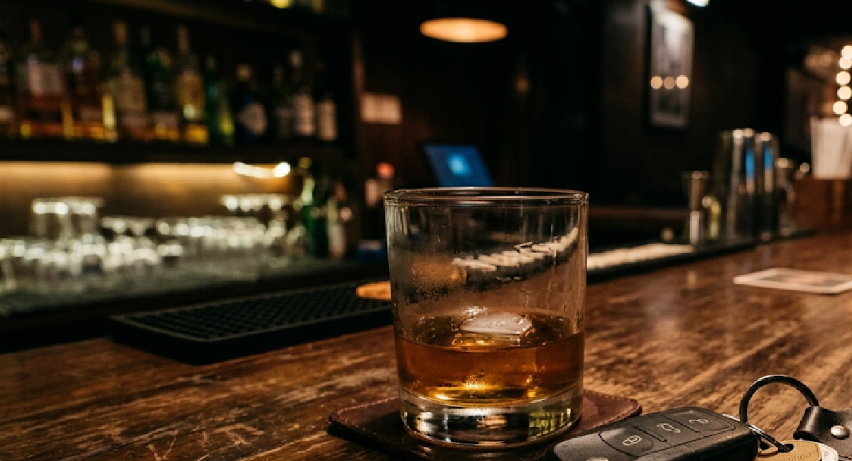 Car key next to a glass of alcohol representing Florida drunk driving accident claims and victims' legal rights